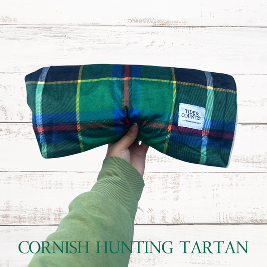 Green Cornish Hunting Tartan Dog Blanket rolled up with Tide & Country label visible in corner